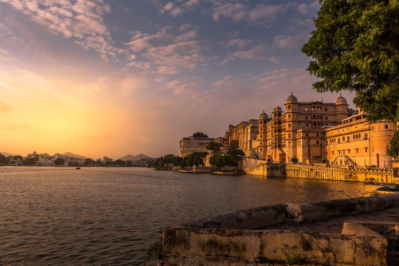 Udaipur city palace on the lake at sunset